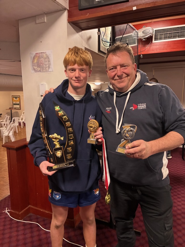 Junior VFC trophy winner with a perpetual trophy alongside a club member holding trophies and medals at the 2026 awards night